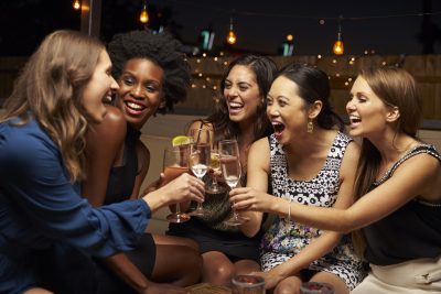 Group of Women Laughing and Toasting With Wine: Bachelorette Party Ideas in PA